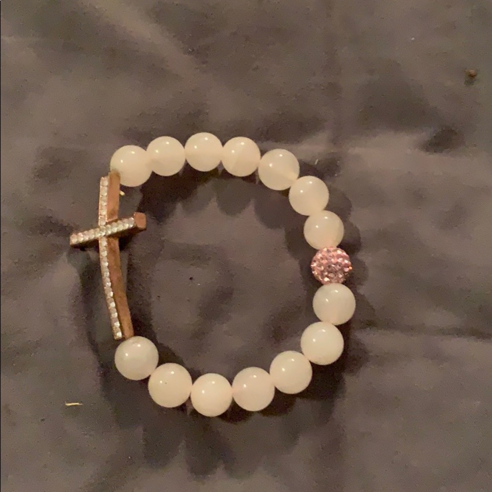 Pink stone bracelet with a cross